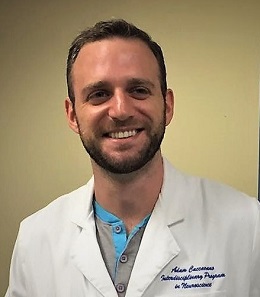 Headshot of medical student Adam Caccavano wearing a white lab coat