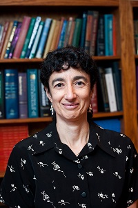 Headshot of Dr. Jonklaas standing in a library wearing a dark shirt with light flowers
