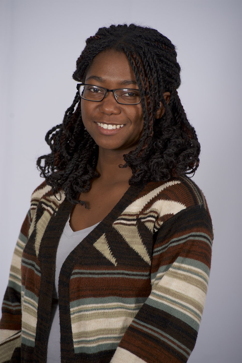 Photo of doctoral student Sikoya Ashburn wearing a striped sweater and glasses